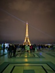 People gather to see the Eiffel Tower light up in a sparkling display